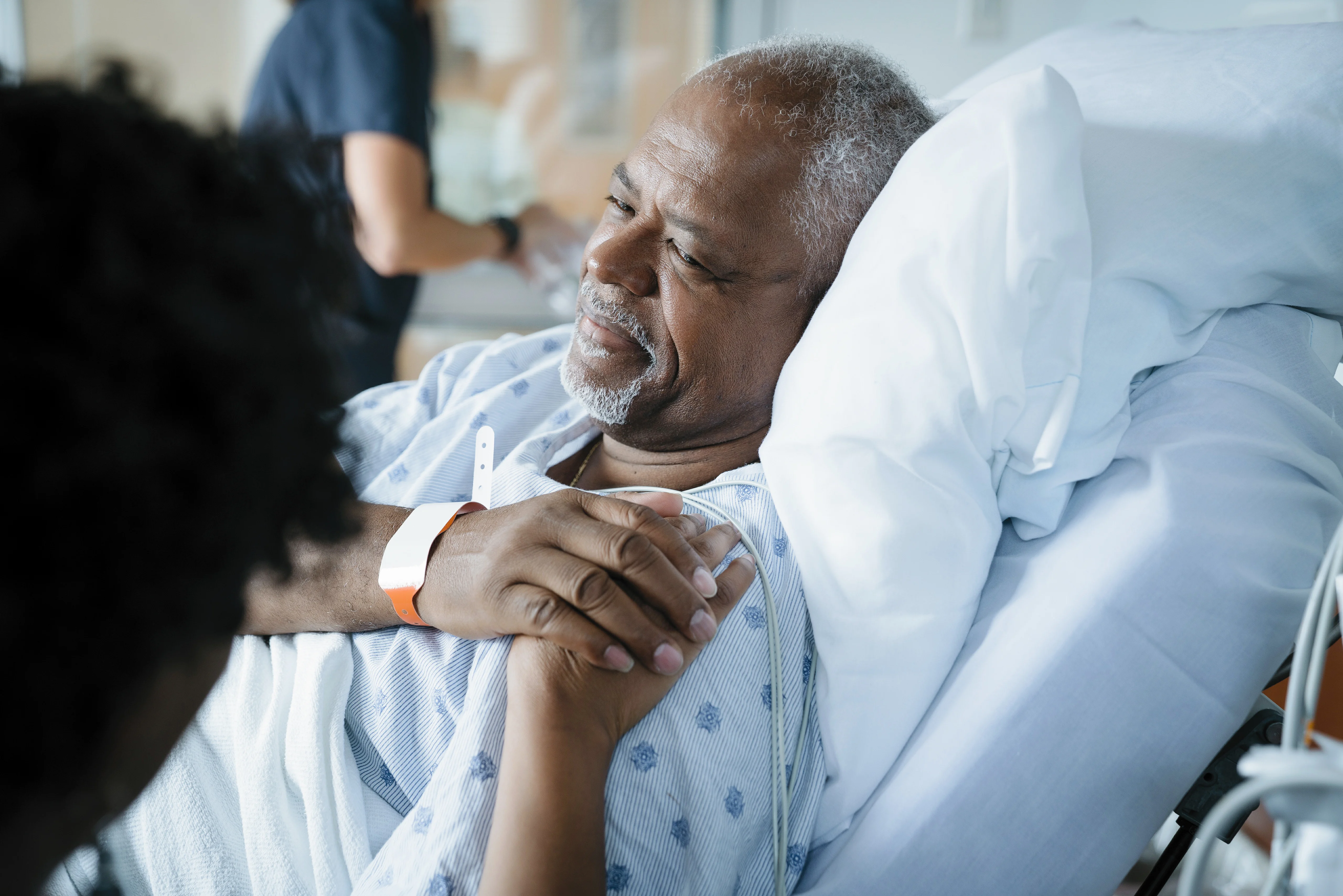 Man holding nurse's hand