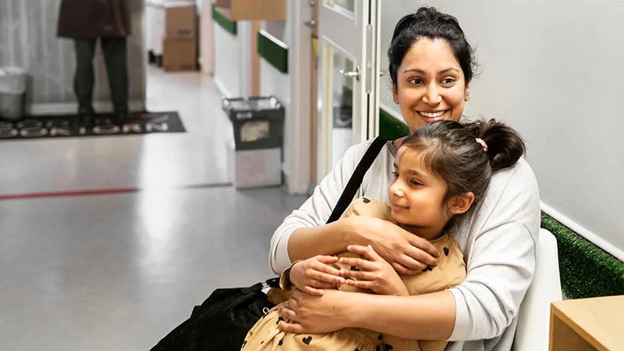 a person holding a child